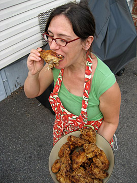 Zora samples a piece of chicken on the way to the table. Quality control, honest