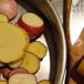 Potatoes sliced thin for Commando Style Roast Chicken